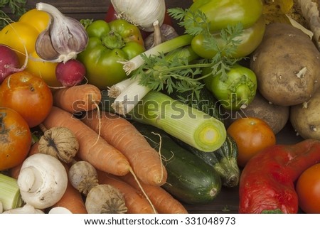 Various types of vegetables on an old wooden table. The concept of diet food. Food for obese patients. Autumn harvest vegetables.