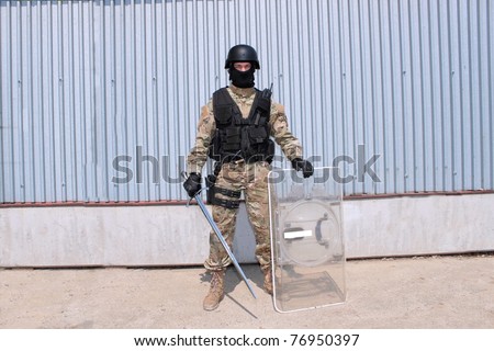 stock-photo-modern-knight-with-a-shield-a-modern-soldier-holding-a-sword-76950397.jpg