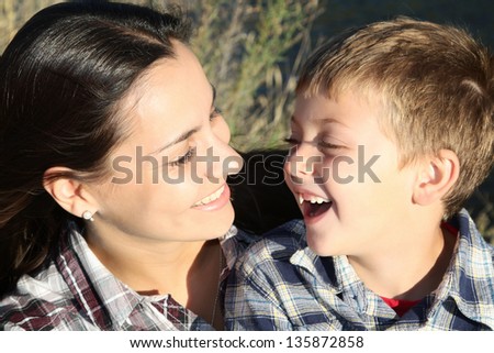 Mother and son outside in the sun having fun