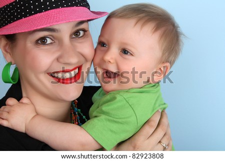 Brunette mother holding her baby boy against her body