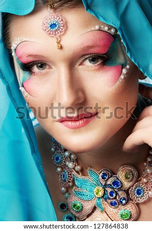 Girl with a beautiful visage and handmade jewelry