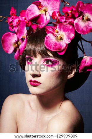 Perfect girl with orchid in her hair