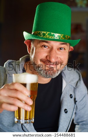Funny Irishman in the national hat drinking beer