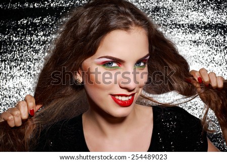 Smiling young woman with hair in hands