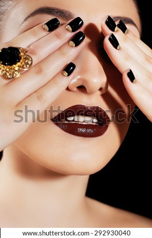 Female face and closed eyes hands, black nail polish, open mouth, sensual lips with shiny lipstick, white healthy teeth