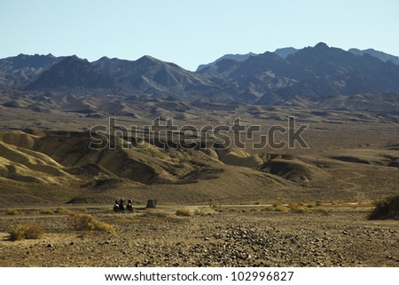A group of cyclists cycle along the hot and scenic death valley national park, California