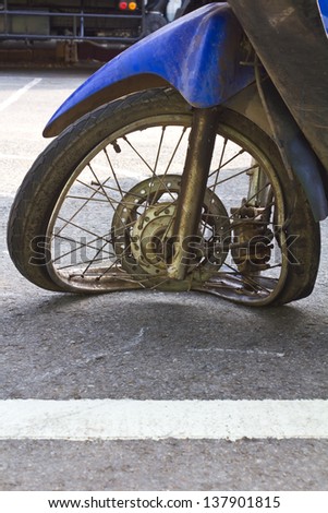Motorcycle front wheel was demolished from the accident.