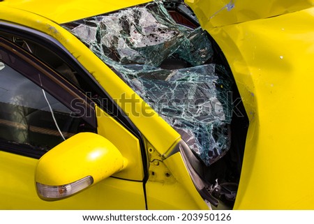 Close up of a Yellow car glass damage caused by accident.