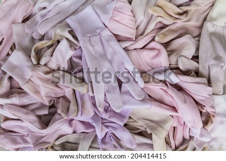 Background pile of white cotton gloves through the use of a long time.