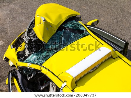 Above the ruins of the yellow car collision accident on the road