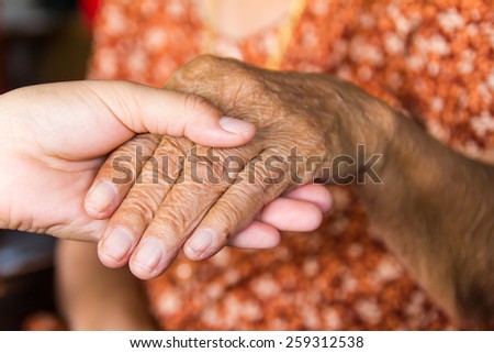Women hold the hand of an elderly grandmother cared for the children.