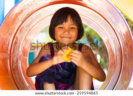 Thailand girls sat cheerfully colored tanks in the playground of the sole.