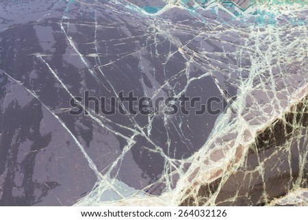 Close up background texture of cracked windshield damage from car accidents.