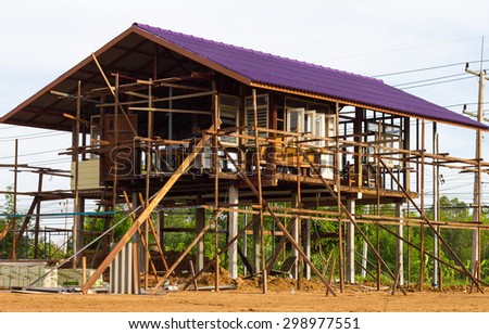 House made of wood reinforced with structural steel box raised roof renovation is not finished.