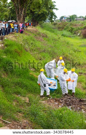 PHICHIT THAILAND-AUGUST 7:\
Scientific staff wear uniforms to prevent toxic chemical waste are stored in a canal countryside.On August 7, 2015 in \
Phichit, Thailand.