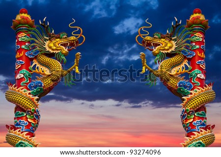 stock photo : Dragons climb the pole. Climb dragons statue two towers in the sky.