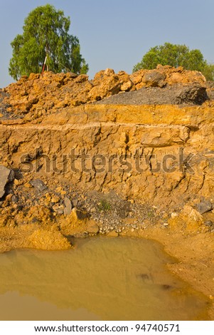Soil under the road. Condition of the road to water erosion as the cliff.