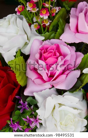 Artificial pink roses. Details of artificial roses, pink, red and white.