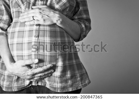 Woman cradling her pregnancy bump