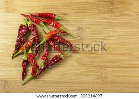 Red hot chili peppers. Dried peppers on wood background with copy space.