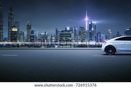 Sport car on roadside with night scene near the modern city background .