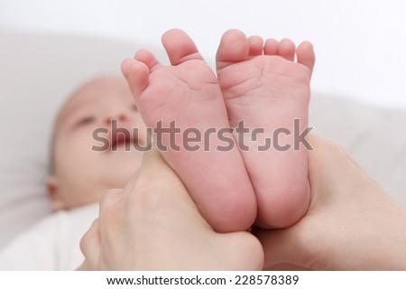 Mother hold her baby's feet