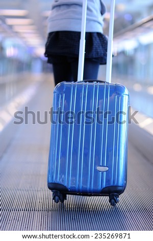 Woman carries luggage at the airport