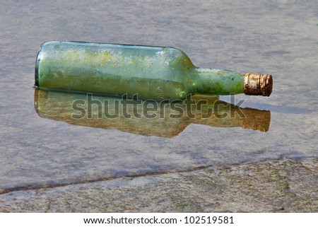 glass bottle floating on the shore