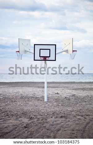three basketball hoops on the beach