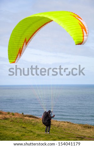 paragliding blast-off at the edge of the cliff
