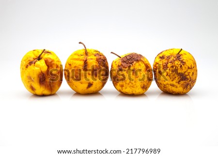 four yellow apples in a bad state