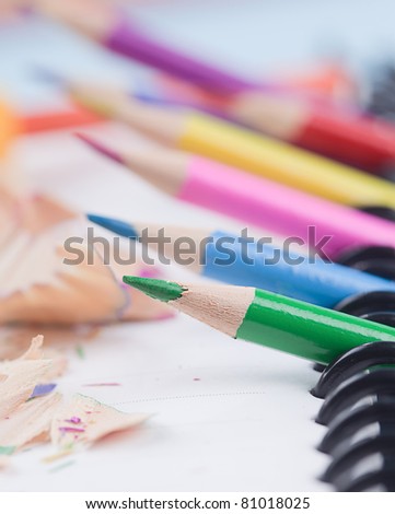 a lot of colored pencils lying on a pad