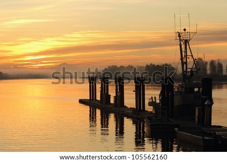 Sunrise in Steveston Harbor, British Columbia, Canada where the commercial fishing fleet waits for the fishing season to open. Located at the mouth of the Fraser River near Vancouver.