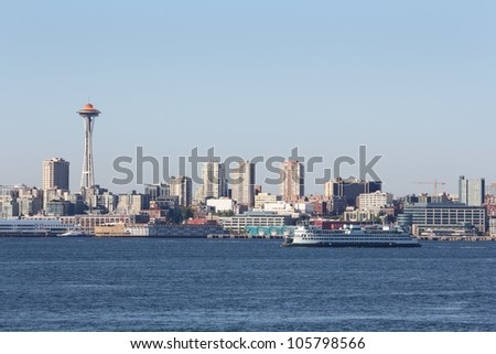 Elliott Bay, Washington State Ferry, Seattle. The view across Elliott Bay at downtown Seattle and the Space Needle. A Washington State Ferry moves across the bay. USA.