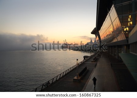 Water\'s Edge, Vancouver. Vancouver\'s Convention Center and Canada Place on Burrard Inlet at dawn. British Columbia, Canada.