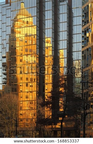 Marine Building Vancouver Reflection. Vancouver\'s old reflected in it\'s new. The historic Marine Building, in downtown Vancouver, is reflected in the glass of a modern office tower.
