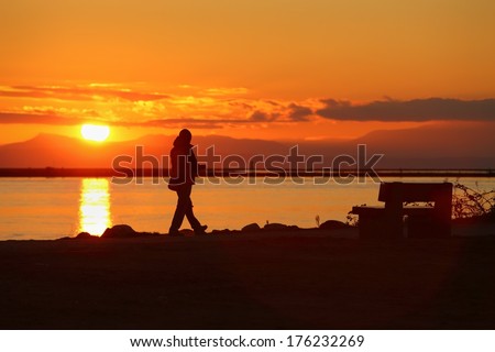 Sunset Walk, Richmond, British Columbia. A walk along the Fraser River at sunset in Richmond, British Columbia. The mountains of Vancouver Island are visible in the background.