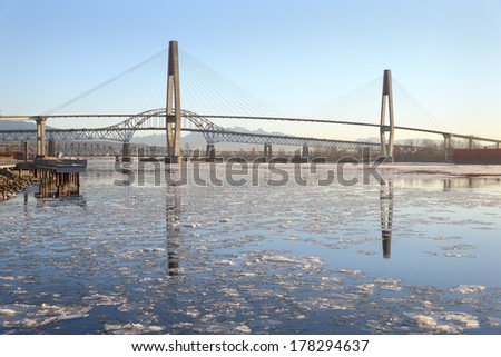 New Westminster, Fraser River Ice. The icy Fraser River flows under three bridges at dawn in New Westminster, British Columbia, Canada.