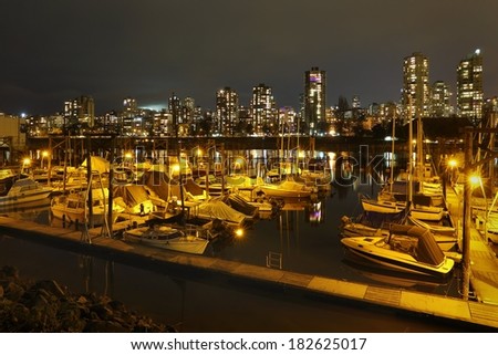 False Creek Marina Night, Vancouver. Looking across a False Creek marina at night towards the apartments and condominiums of Vancouver\'s West End. British Columbia, Canada.