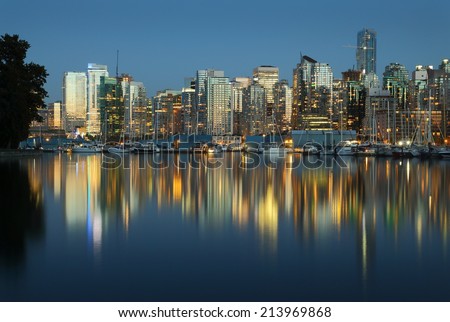 Coal Harbor, Evening Twilight, Vancouver. Downtown Vancouver skyline at sunset looking across Coal Harbor from Stanley Park, British Columbia, Canada.
