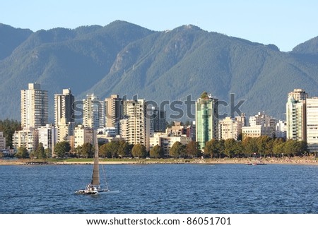 The view, in the early evening, across English Bay, the apartments of the West End, and the North Shore Mountains in Vancouver, British Columbia, Canada.