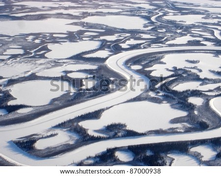 Aerial view of Canada\'s longest river, the Mackenzie River, empties into the Beaufort Sea, Arctic Ocean in a region known as the Mackenzie Delta. The Mackenzie Delta is the largest delta in Canada.