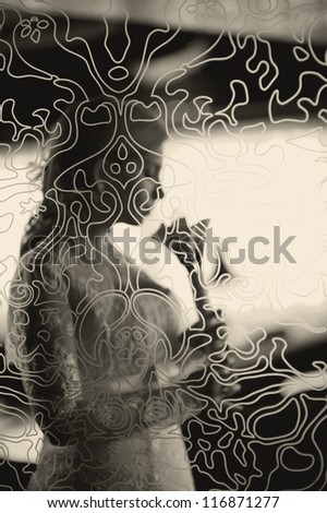 Silhouette of bride besides the window with her wedding bouquet