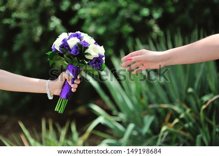 Bride hold wedding bouquet with white and lilac roses