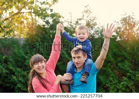 happy parents and son enjoyed a walk in the park.