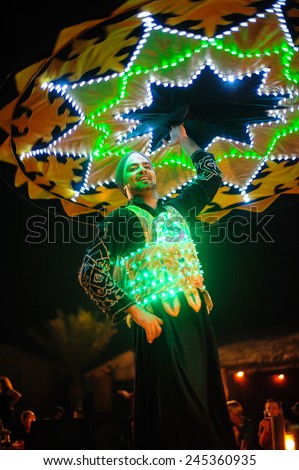 Dubai, UAE, December 10, 2013, a man with a skirt dances national dance.