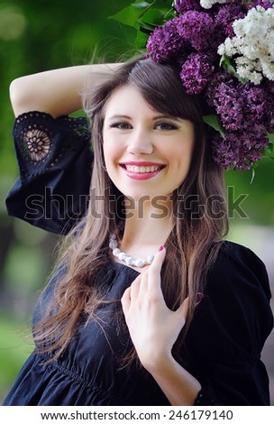 woman with a bouquet of lilacs in the spring in the park.