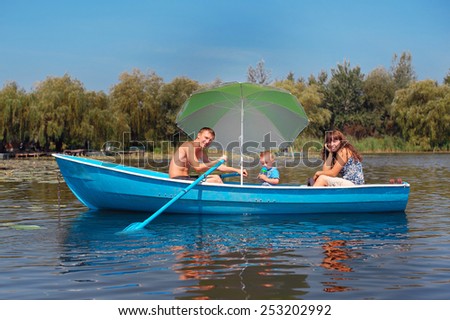 family riding on a boat in the summer.