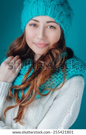 young woman in knit scarf and hat mint color.