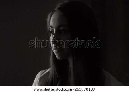 Beautiful girl looking out the window. Black and white photographs